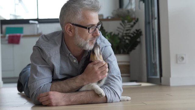 Man with puppy dog at home