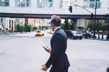 Middle aged entrepreneur crossing road