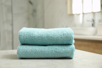 Fototapeta na wymiar Stack of clean towels on table indoors