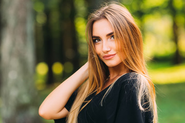 Naklejka premium Portrait of a young woman with a beautiful makeup. brunette