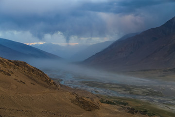 The valley of the Pyandzh River at dawn in the rays of the rising sun, on the border with Avganistan