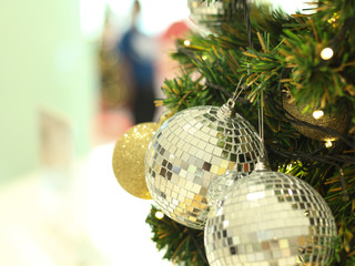 bauble hanging from a decorated Christmas tree. Retro filter effect