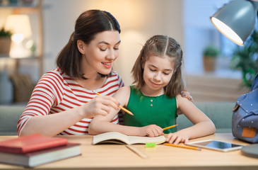 Girl doing homework with mother