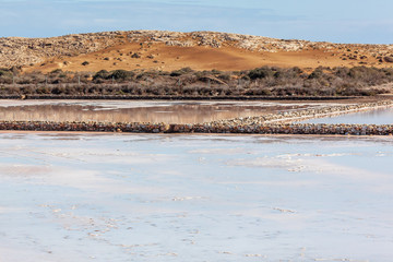 Scenic view of pink mirror-like salt pools located within Calblanque Regional natural Park, Murcia,...