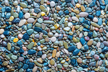 Wet and dry sea pebble texture as background