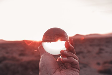 Reflections of the mountain through a lens ball with sunset in Lanzarote, Canary Island 