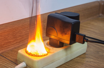 Electrical fire in outlet in apartment. Defective old outlet and electric short circuit is cause of...