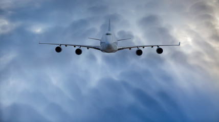 Commerical airplane flying under the storm clouds