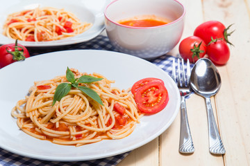 Spaghetti pasta with and tomato sauce on wood background