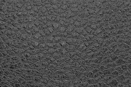 Artificial testure resembling wet asphalt with a rough surface.