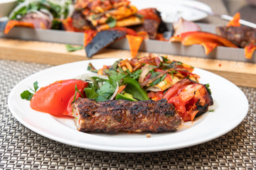 Kebab with vegetables and pita bread - traditional Turkish dish. Cooked on fire