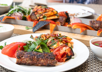 Kebab with vegetables and pita bread - traditional Turkish dish. Cooked on fire