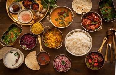South Indian vegetarian dishes served in thali style on wooden table