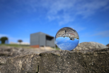 The villa of Veranes is reflected over a glass sphere  - 320566459