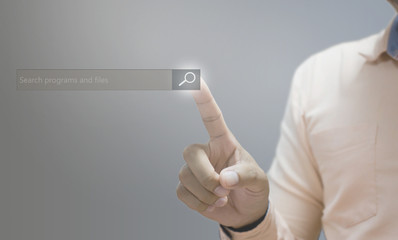 Technology  searching system and internet concept  man hand pressing Search button