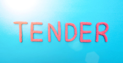 The word tender in red letters on a blue background. The concept of competitive procurement from a good specialist, market
