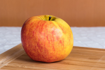 A fresh apple on a kitchen table