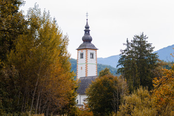 Old church in autumn near lake