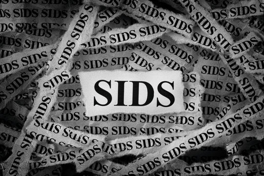 Strips Of Newspaper With SIDS Typed On Them (Sudden Infant Death Syndrome)