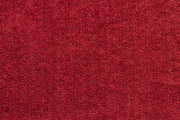 Red knit fabric background. Colorful wool sweater texture