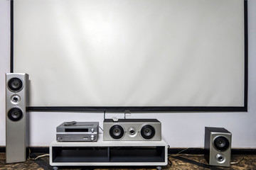 Home cinema. Large white screen home theater system with stereo