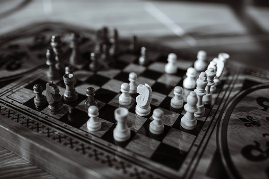 Black and white photo with an image of a chessboard and chess pieces,