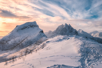 Segla mountain with snowy hill in colorful morning sky at Senja Island
