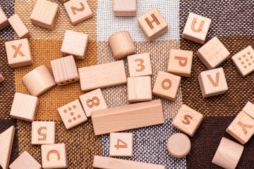 Wooden Blocks on the Bed with English Alphabet and Symbols