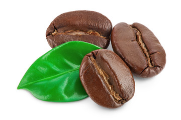 Heap of roasted coffee beans with leaves isolated on white background with clipping path and full depth of field.