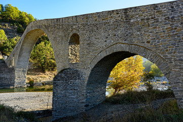 Fototapeta na wymiar View of the traditional stone bridge of Aziz Aga near Grevena in northwestern Greece