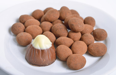 Sweets with almonds and cocoa powder. On white background