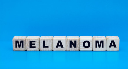 concept word melanoma on cubes on a blue background