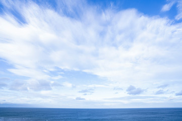 Plakat Seascape with sea horizon and beautiful sky line with clouds. Blue Ocean and sea with white cloud on blue sky in spring or summer