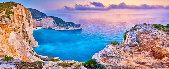Washable wall murals Navagio Beach,  Zakynthos, Greece Navagio Beach with shipwreck view on Zakynthos island, Greece. Incredibly romantic sunrise on Zakinthos. Amazing sunset view with multicolored clouds. Island of lovers. Doors to heaven