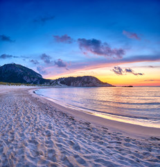 Amazing sunset view with multicolored clouds. Incredibly romantic sunrise on Voidokilia beach, Ionian Sea, Pilos town location, Greece, Europe. View of the ocean. Tropical beach