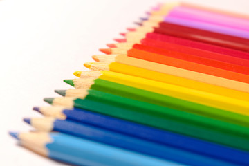 Different colored pencils on white background