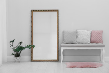 Modern large mirror and comfortable bench near light wall in room - obrazy, fototapety, plakaty