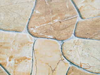 Marble tile looking like stone rocks glued together making an interesting floor design in the home or a cool modern wallpaper