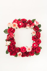 Flat lay frame border with blank copy space mockup made of pink and red rose flowers on white background. Top view floral concept.