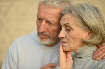 Close up portrait of sad thoughtful senior couple 