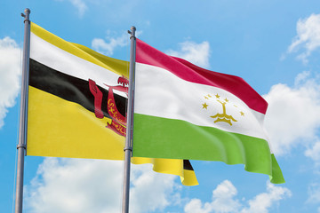 Tajikistan and Brunei flags waving in the wind against white cloudy blue sky together. Diplomacy concept, international relations.