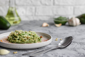 Green pasta with avocado, spinach and pine nuts