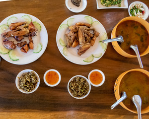 Selection of burmese dishes in rural Myanmar with skinny chicken and traditional soup