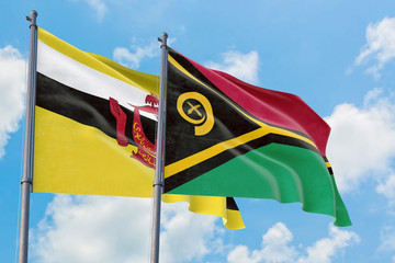 Vanuatu and Brunei flags waving in the wind against white cloudy blue sky together. Diplomacy...