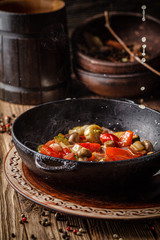 European cuisine in Ukrainian style. Warm grilled vegetable salad with beer in smoke. Serving meals in a rustic restaurant. background image, copy space text