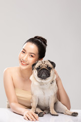 Beautiful Attractive Charming Asian young woman smile with her dog pug breed feeling so happy and cheerful with healthy skin,isolated on white background