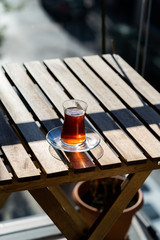 Traditional Turkish Tea at Balcony of Home on Wooden Table.