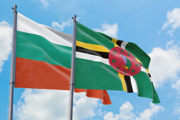 Dominica and Bulgaria flags waving in the wind against white cloudy blue sky together. Diplomacy...