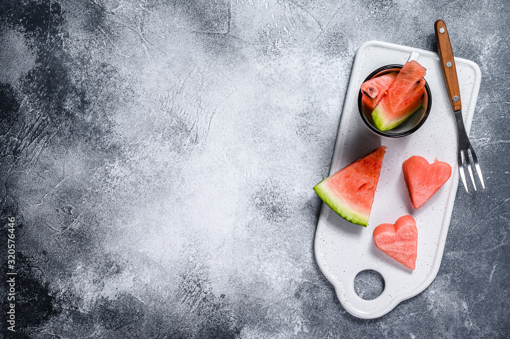 Wall mural Slices of ripe watermelon in the shape of a heart. Concept of love. Gray background - Wall murals