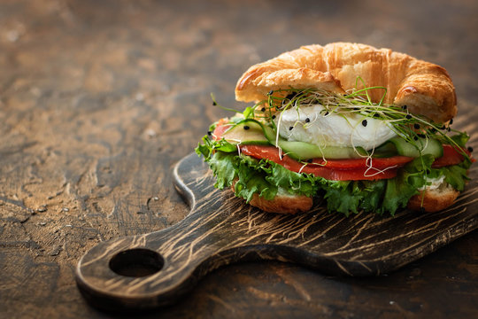 Croissant Fish And Poached Egg Sandwich